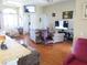 Bright living room boasts hardwood floors with multiple seating areas and a view of the entryway at 4770 Sw 114Th St, Ocala, FL 34476