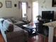 Cozy living room featuring hardwood floors, TV, and comfortable seating at 4770 Sw 114Th St, Ocala, FL 34476