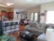 Open-concept living room showcases a seamless flow to the kitchen and dining areas with hardwood floors at 4770 Sw 114Th St, Ocala, FL 34476