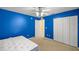 Vibrant blue bedroom with carpeting, closet, and mattress at 4939 Sw 99Th Pl, Ocala, FL 34476