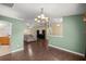 Dining area with an elegant chandelier and hardwood floors at 4939 Sw 99Th Pl, Ocala, FL 34476