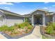 Inviting front entry with a landscaped garden and a classic, covered entrance at 4939 Sw 99Th Pl, Ocala, FL 34476