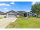 Charming single-story home with a well-manicured lawn and a two-car garage at 4939 Sw 99Th Pl, Ocala, FL 34476