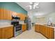 Functional kitchen featuring stainless steel appliances and wood cabinets with an eat-in dining area at 4939 Sw 99Th Pl, Ocala, FL 34476