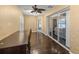 An office space with hardwood flooring and sliding glass doors, offering a bright work environment at 4939 Sw 99Th Pl, Ocala, FL 34476