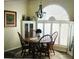 Bright dining area with a round table, seating for four, updated light fixture, and modern flooring at 5281 Sw 33Rd St, Ocala, FL 34474