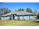 Charming single-story home featuring a well-manicured lawn, arched windows, and neutral exterior paint at 5281 Sw 33Rd St, Ocala, FL 34474