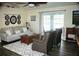 Cozy living room features comfortable seating, a ceiling fan, and a sliding glass door for natural light at 5281 Sw 33Rd St, Ocala, FL 34474