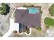 Overhead image of a home with a screened in pool, long driveway, and solar panels at 6045 Ne 65Th St, Silver Springs, FL 34488