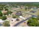Stunning aerial shot of a luxurious green home with a long driveway, set among mature trees and greenery at 6045 Ne 65Th St, Silver Springs, FL 34488