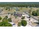Expansive aerial view of a well-maintained green house with a private pool and surrounding lush greenery at 6045 Ne 65Th St, Silver Springs, FL 34488