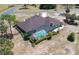 Beautiful aerial showing a home with a screened-in pool and a well-maintained backyard landscaping at 6045 Ne 65Th St, Silver Springs, FL 34488