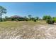 Expansive backyard with lush green lawn, mature trees, and a charming gazebo, perfect for outdoor enjoyment at 6045 Ne 65Th St, Silver Springs, FL 34488