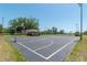 Community basketball court, with lighting, set amidst lush greenery and nearby tennis courts at 6045 Ne 65Th St, Silver Springs, FL 34488