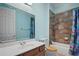 Light blue bathroom featuring a tiled bath and shower, and a single vanity at 6045 Ne 65Th St, Silver Springs, FL 34488