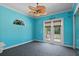 Blue bedroom featuring french doors with blinds and a decorative window at 6045 Ne 65Th St, Silver Springs, FL 34488