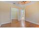Bedroom with wood laminate flooring, tan walls with a view into the bathroom and walk-in closet at 6045 Ne 65Th St, Silver Springs, FL 34488