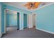 Blue bedroom featuring mirrored closet doors and an adjacent closet at 6045 Ne 65Th St, Silver Springs, FL 34488