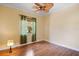 Bedroom with wood laminate flooring, tan walls and a tropical ceiling fan at 6045 Ne 65Th St, Silver Springs, FL 34488