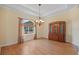 Elegant dining room featuring wood floors, a chandelier, and a window, creating a warm and inviting atmosphere at 6045 Ne 65Th St, Silver Springs, FL 34488