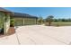 Wide driveway leads to a two-car garage, complemented by solar panels, and professional landscaping at 6045 Ne 65Th St, Silver Springs, FL 34488