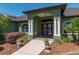 Stately entrance with double doors, white columns, and decorative planters at 6045 Ne 65Th St, Silver Springs, FL 34488