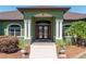 Elegant entrance with arched doorway, double doors, and decorative columns at 6045 Ne 65Th St, Silver Springs, FL 34488