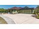 Charming home exterior with a spacious driveway, solar panels, and an attached two-car garage at 6045 Ne 65Th St, Silver Springs, FL 34488