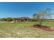 Attractive one-story home with lush front lawn, mature landscaping, and an American flag at 6045 Ne 65Th St, Silver Springs, FL 34488
