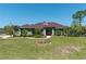 Inviting single-story home showcases lush landscaping, a charming walkway, and the American flag at 6045 Ne 65Th St, Silver Springs, FL 34488