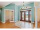Bright foyer showcases elegant double doors and an entrance to another living area at 6045 Ne 65Th St, Silver Springs, FL 34488