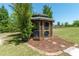 Beautiful gazebo nestled amidst trees, creating a serene outdoor oasis with well manicured landscaping at 6045 Ne 65Th St, Silver Springs, FL 34488