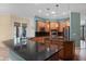 Open concept kitchen with wooden cabinets, black granite countertops, and stainless steel appliances at 6045 Ne 65Th St, Silver Springs, FL 34488