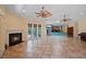 Expansive living room featuring a fireplace, tiled floors, and French doors to outdoor living space at 6045 Ne 65Th St, Silver Springs, FL 34488