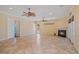 Large living room with fireplace and tile flooring for easy maintenance at 6045 Ne 65Th St, Silver Springs, FL 34488