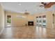 Spacious living room with fireplace and multiple French doors opening to the pool area at 6045 Ne 65Th St, Silver Springs, FL 34488