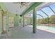 Screened-in pool area with multiple entrances, brick flooring, and a ceiling fan for maximum comfort at 6045 Ne 65Th St, Silver Springs, FL 34488