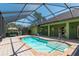 Beautiful pool with waterfall feature, surrounded by lush greenery, and a screened-in enclosure at 6045 Ne 65Th St, Silver Springs, FL 34488