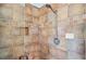 A tiled shower showcasing the showerhead and built-in shelving at 6045 Ne 65Th St, Silver Springs, FL 34488