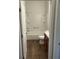 Bathroom features a shower-tub combo with vanity and a wood-look floor at 627 Vagabond St, The Villages, FL 32163