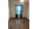 Secondary bedroom with light-filled window and neutral walls over wood-look flooring at 627 Vagabond St, The Villages, FL 32163