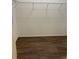 Walk-in closet with white shelving and rack, over wood-look flooring at 627 Vagabond St, The Villages, FL 32163