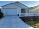 Charming single-story home with a two car garage, white picket fence, and well manicured landscaping at 627 Vagabond St, The Villages, FL 32163