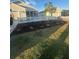 Charming front yard featuring a white picket fence, manicured lawn, and landscaped flowerbeds at 627 Vagabond St, The Villages, FL 32163