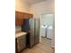 Galley kitchen with stainless steel appliances and direct access to the laundry room with washer and dryer at 627 Vagabond St, The Villages, FL 32163