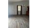 An open living area featuring wood-look floors, vaulted ceilings and a contemporary chandelier at 627 Vagabond St, The Villages, FL 32163