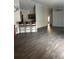 Open living space with wood floors, vaulted ceiling, ceiling fan and breakfast bar with seating at 627 Vagabond St, The Villages, FL 32163