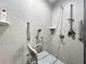 Accessible bathroom featuring tiled walls and handrails offering safety and convenience at 6671 Se 108Th St, Belleview, FL 34420