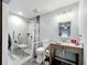 Accessible bathroom with tiled walls and shower featuring handrails offering safety and convenience at 6671 Se 108Th St, Belleview, FL 34420