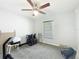 Simple bedroom featuring plush carpet, a ceiling fan, and a bright window at 6671 Se 108Th St, Belleview, FL 34420